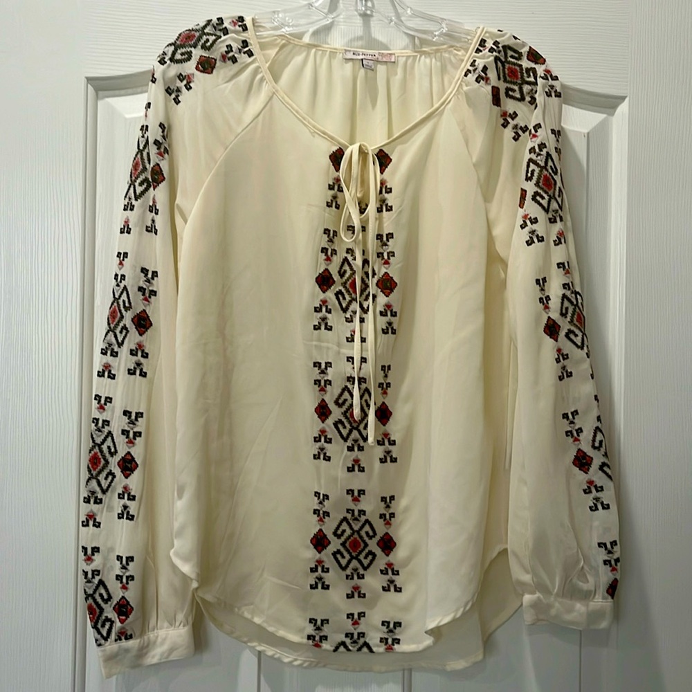 Beige peasant blouse with embroidery down front and sleeves.